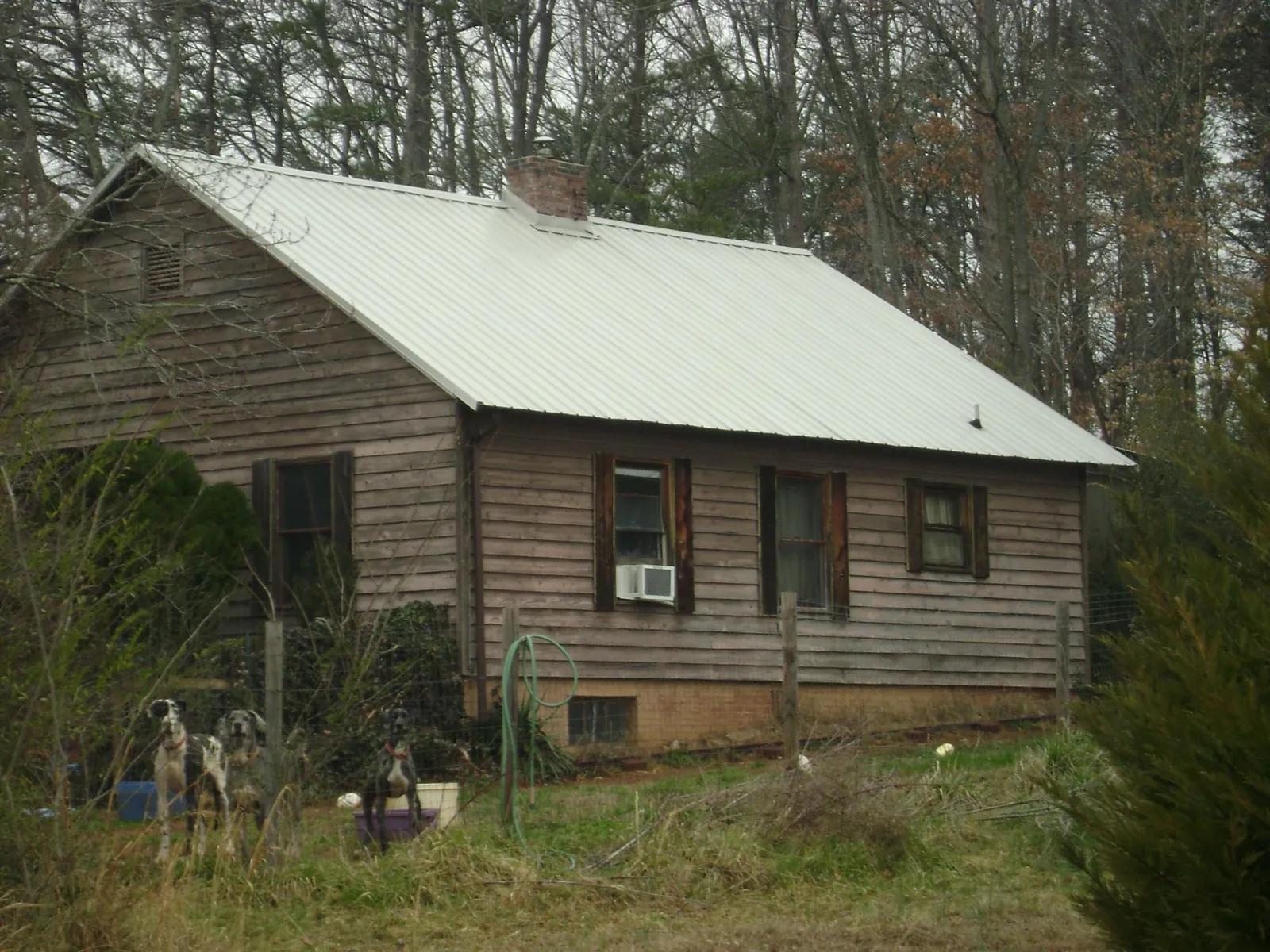 White metal roof on an old wood sided farmhouse, from a Metal Roof Installation job in Lancaster